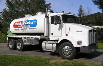 Photo of a white septic truck with a large logo on the side.